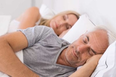 husband and wife sleeping in bed